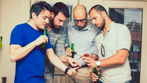 Explore alcohol use in the gay community with this image of a group of gay men holding bottles of alcoholic beverages.