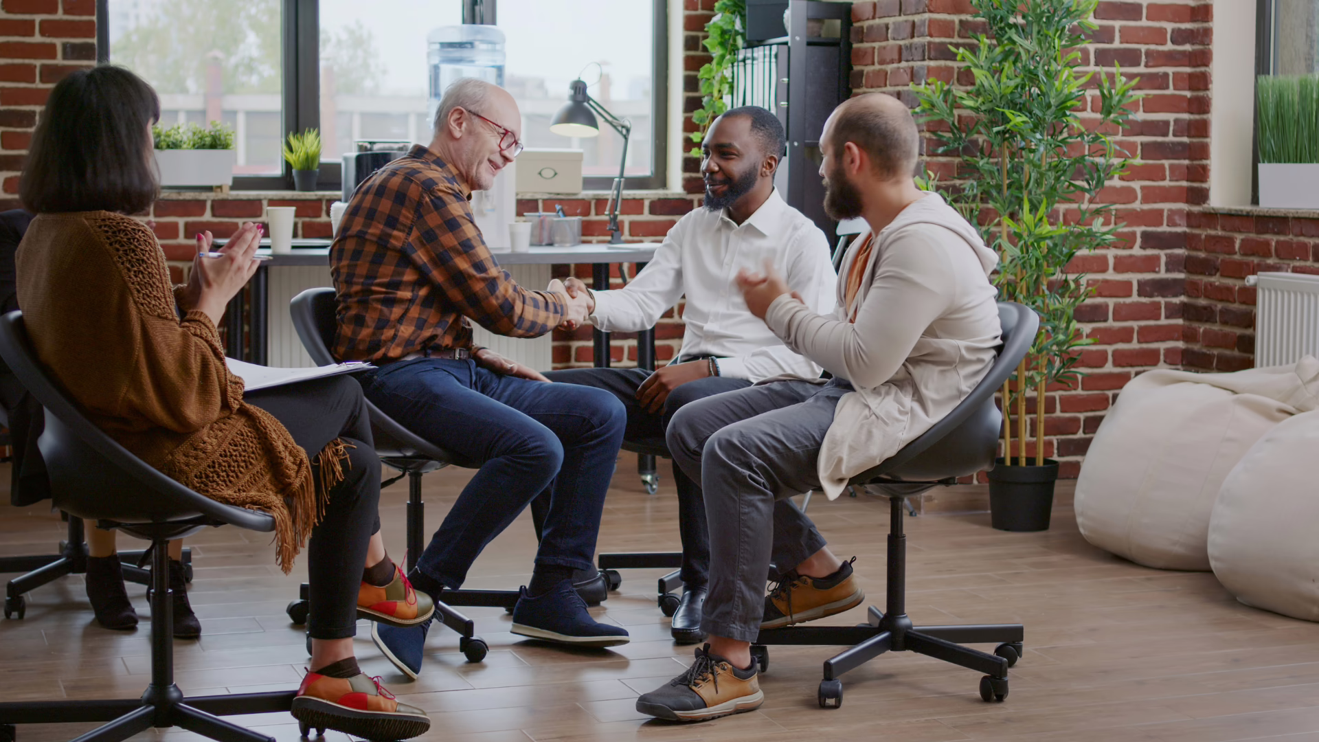 Gay folks and a therapist during group therapy in a gay rehab.